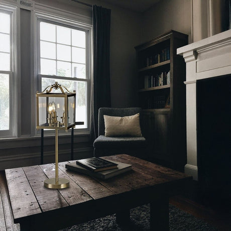Cozy reading nook with brass table lamp on rustic wooden coffee table by the window.