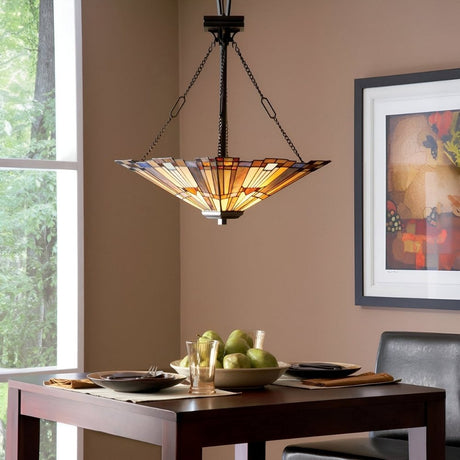 Dining area with stained glass pendant light hanging above a wooden table set for two.