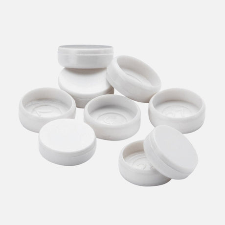 Round white plastic end caps scattered in a group on a white background.