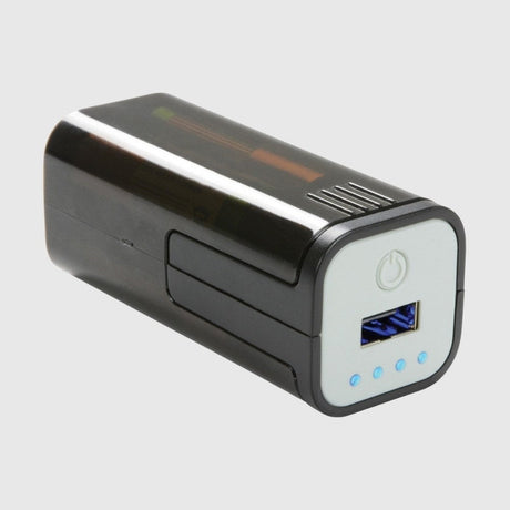 A black and silver portable power bank featuring a digital display, power button, and USB output ports.