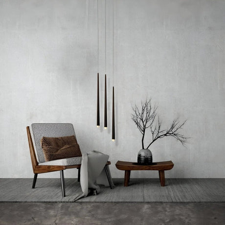 Minimalist corner with wooden chair, side table, and hanging pendant lights.
