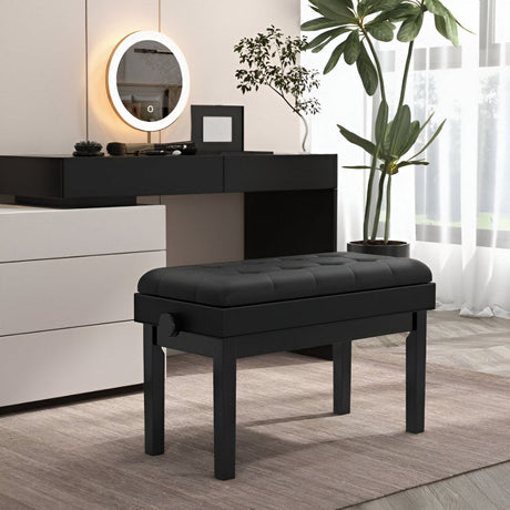 Black padded piano bench placed in a modern room with a vanity table and indoor plant.