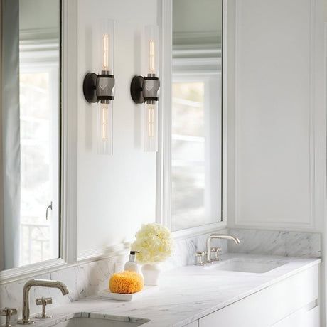 Bathroom vanity with marble countertop, modern wall sconces, and soft natural light from nearby windows.