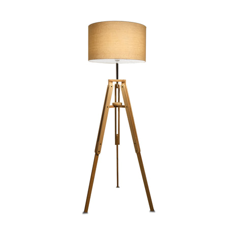 The Gaia Wood Floor Lamp - Light Brown showcases a natural wood tripod base paired with a beige cylindrical fabric shade, offering rustic charm.