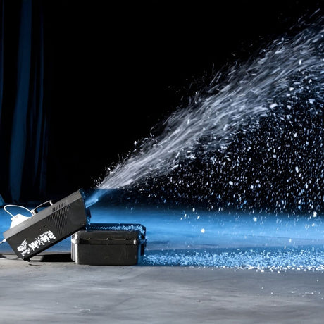 Snow machine shooting artificial snowflakes across a stage, creating a winter-like visual effect.