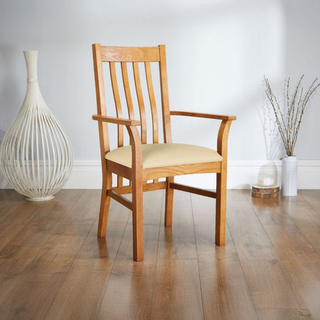Wooden armchair with cushioned seat placed on a polished wood floor.