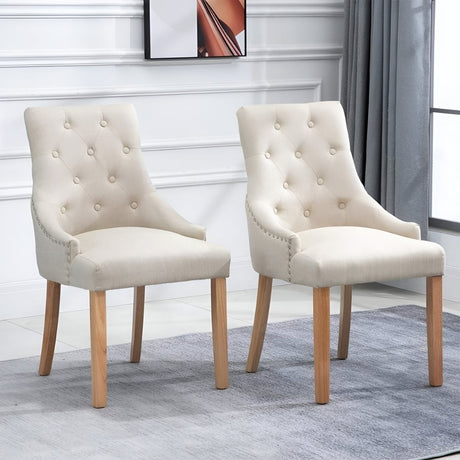 Pair of cream tufted dining chairs with wooden legs, arranged in a bright room with soft drapery and neutral decor, offering a blend of classic elegance and modern simplicity.