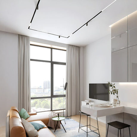 Bright living space with geometric ceiling track lighting and desk area.