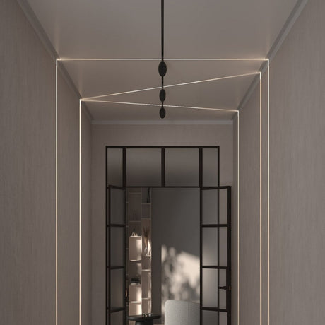 Hallway with recessed ceiling lighting lines forming geometric shapes.
