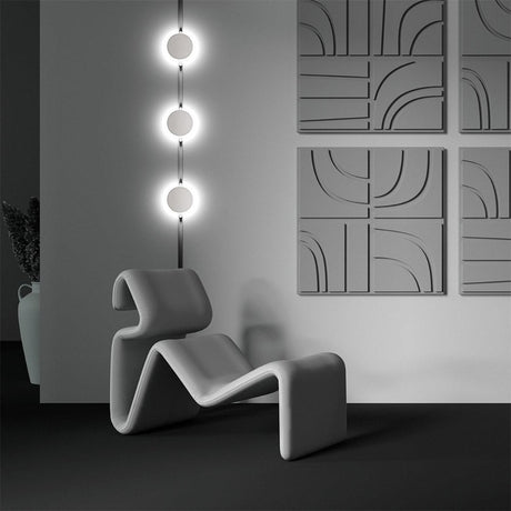 Modern interior with vertical wall lights and sculptural chair.