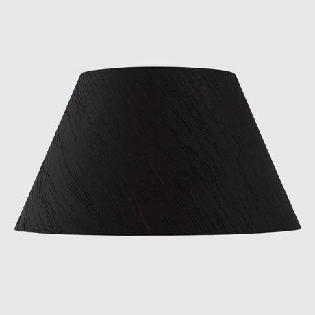 Black lampshade with a tapered cylindrical shape.