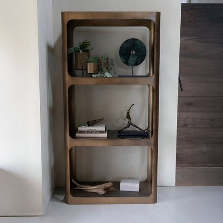 Modern open bookshelf with rounded edges displaying decor and books.