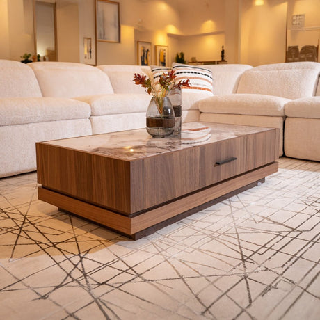 Modern living room with marble-top wooden coffee table and beige sectional sofa.