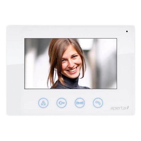 Video intercom screen showing a smiling person with long hair in a bun, wearing a gray turtleneck. The intercom has four buttons with icons below the screen, set in a white frame.