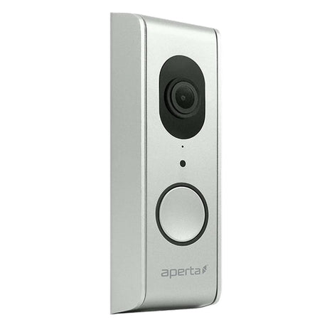 Silver rectangular video doorbell with a camera lens at the top and a circular button below. The brand name aperta is printed near the bottom. The design is sleek and modern.