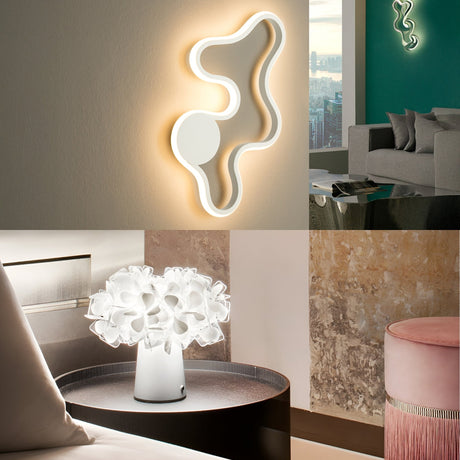 A modern interior features a sculptural wall lamp, a grey couch with pillows, a decorative white table lamp on a round table, and a textured wall with a pink velvet stool in front.