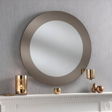 Large round bronze framed mirror above a fireplace