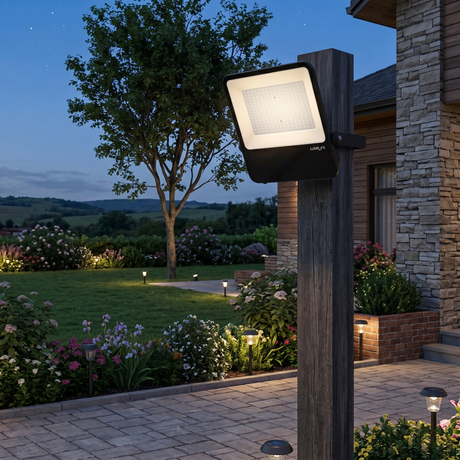 Outdoor floodlight mounted on a ribbed metal wall for security lighting.