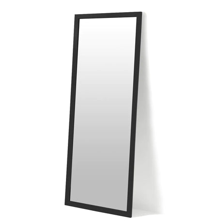 A full-length rectangular mirror with a black frame stands at an angle against a white background.