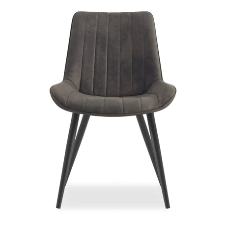 A modern chair with a cushioned, dark gray seat featuring vertical stitching. It has slender black metal legs that angle outward. The design is sleek and minimalist.