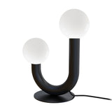Rigoberta 2 Light Opal Glass Globe Table Lamp in matt black, curved U-shaped iron tube with two opal glass globes at uneven heights, round base, plain white background.