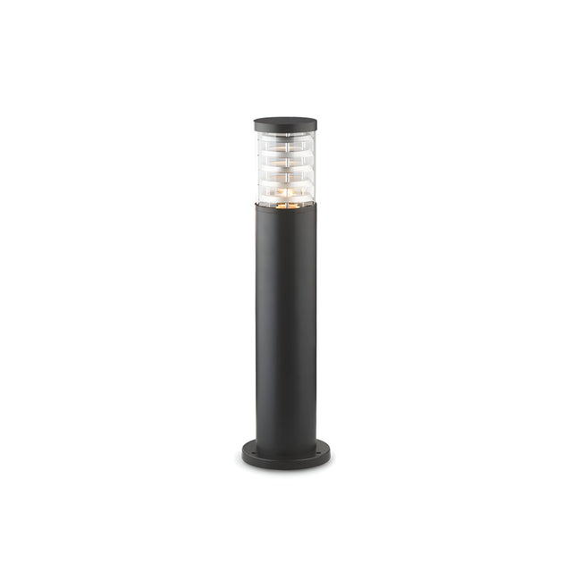 The Luminis Outdoor Bollard Light - Black, 60cm showcases a sleek and minimalist cylindrical design with a transparent top section featuring horizontal lines, complemented by a solid dark base. Constructed from die-cast aluminium, it is perfect for garden or pathway lighting.
