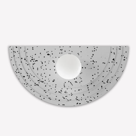 Regina Globe Wall Light with half-round Terrazzo White panel, black-flecked finish in stepped rings around a central opal glass globe, shown on a plain white background.