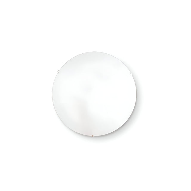 A round, minimalist mirror with a thin frame is mounted on a white wall, embodying a true minimalist aesthetic. The surface reflects light beautifully, creating a soft ambient glow that perfectly complements the Velum 2 Light Ceiling & Wall Light in White.