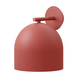 Rio Dome Wall Light in red, showing a round wall plate and slim arm supporting a bell-shaped dome shade with an open base, iron finish, on a plain white background.