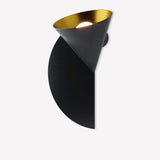 Rubi wall light with a matt black cone shade lined in gold, angled over a black half-disc backplate, shown on a plain white background.