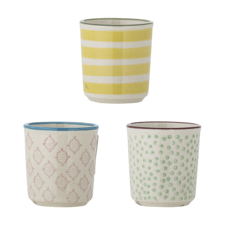 Patrizia ceramic egg cups in three assorted designs on a white background: yellow and white stripes, pink patterned with blue rim, and green dots with a burgundy rim.