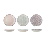 Maya Dinner Plate in assorted designs, three round stoneware plates with pink chevron, mint fern, and purple floral patterns, shown from above and side on a white background.