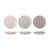 Maya ceramic side plates, 22cm, shown from above and in profile in three patterned designs—pink floral, grey floral, and burgundy chevron—on a plain white background.