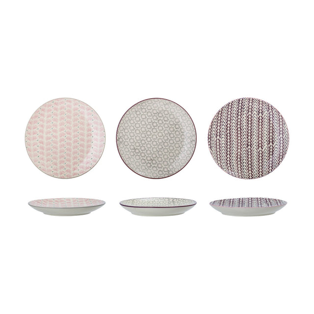Maya ceramic side plates, 22cm, shown from above and in profile in three patterned designs—pink floral, grey floral, and burgundy chevron—on a plain white background.