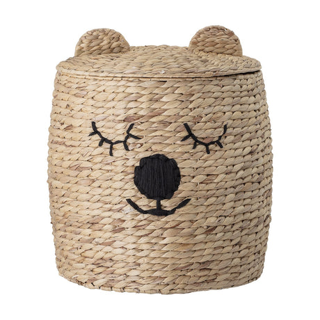 Dolma Bear Water Hyacinth Basket with Lid in natural woven wicker, featuring rounded ears, stitched sleepy eyes, nose and smile, shown on a plain white background.