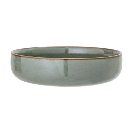 Pixie Stoneware Bowl 20cm in Green, a low wide ceramic bowl with straight sides, glossy speckled reactive glaze, and a brown rim, shown on a plain white background.