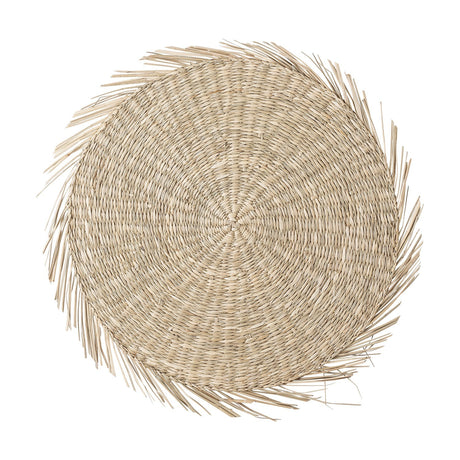 Ilsa Seagrass Placemat in natural, a round woven mat with tight concentric rings and a frayed fringe edge, shown on a plain white background.
