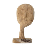 Cacia Wooden Ornament in natural reclaimed wood, a carved face with closed eyes resting on an open hand, tapering stem and block base, shown against a plain white background.