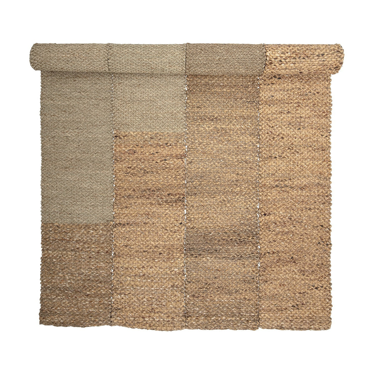 Enzov Seagrass Rug 245x150cm in Natural, partially rolled, showing four braided panels in varying earthy tones with visible stitched seams, on a plain white background.