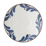 Camellia Porcelain Plate in cream, a small round side plate with speckled surface, blue leaf border and dots, dark rim line, on a plain white background.