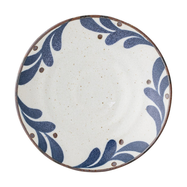 Camellia Porcelain Plate in cream, a small round side plate with speckled surface, blue leaf border and dots, dark rim line, on a plain white background.