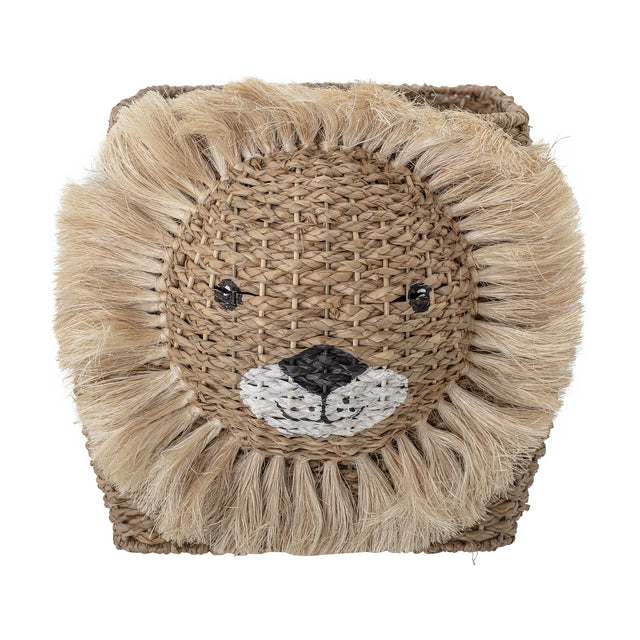 Harrison Basket in beige woven bankuan grass, shaped like a lion's face with a fringed mane, embroidered eyes and nose, shown against a plain white background.