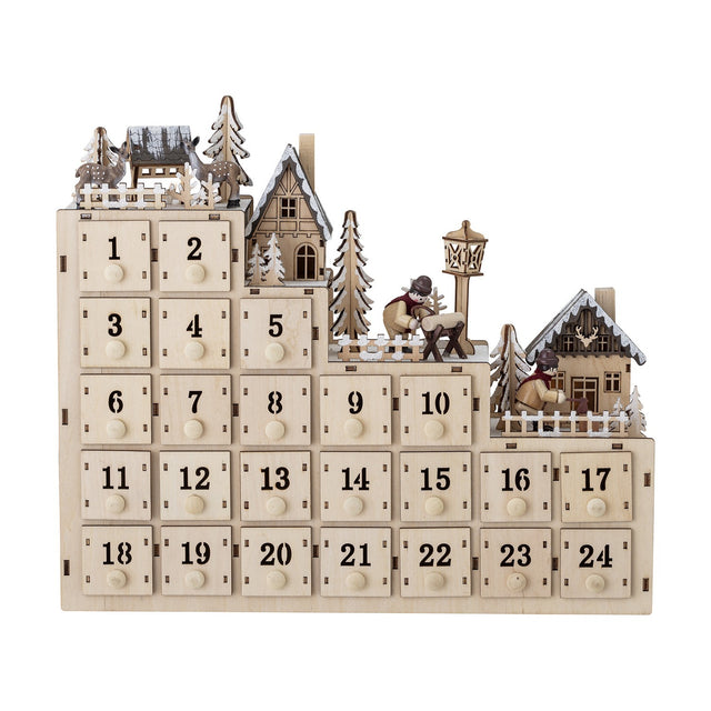Richie Wooden Advent Calendar with Light in natural plywood, featuring 24 numbered drawers with round knobs beneath a tiered miniature winter village with houses, fir trees, and figures.