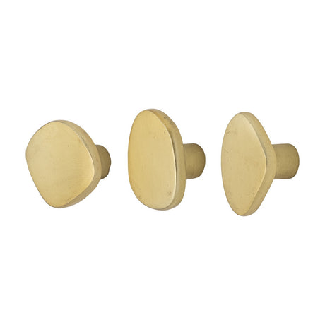 Ferri Aluminium Wall Hooks Set of 3 in brass, each with a flat pebble-shaped face on a short round stem in varying organic outlines, shown on a plain white background.