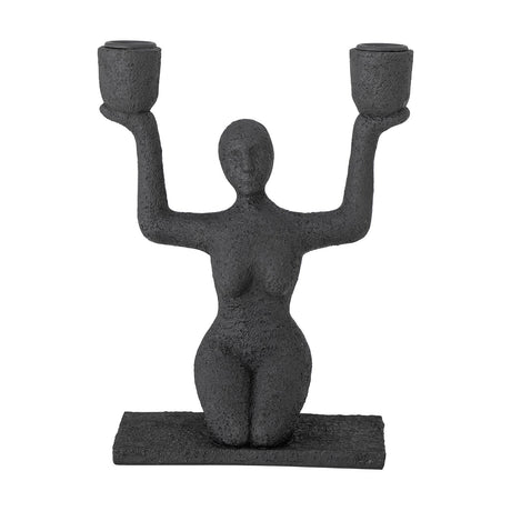 Lucie Resin Candle Holder in black, a textured kneeling female figure raising both arms to hold two cup-shaped candle holders, on a flat rectangular base against a plain white background.