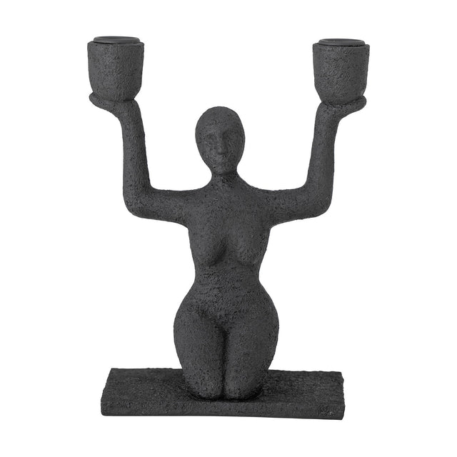 Lucie Resin Candle Holder in black, a textured kneeling female figure raising both arms to hold two cup-shaped candle holders, on a flat rectangular base against a plain white background.