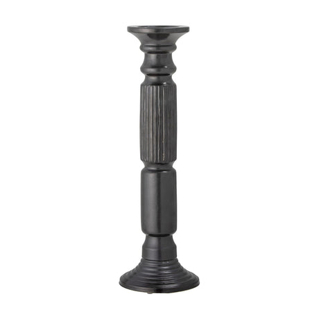 Millas Fluted Ceramic Candle Holder in black, a tall pillar-shaped column with vertical fluted texture on the stem and a wide shallow dish top, set on a plain white background.