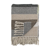 Isnel Black Striped Cotton Throw folded to show black, beige and white woven stripes with knotted fringe, against a plain white background.