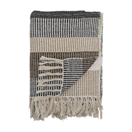 Isnel Black Striped Cotton Throw folded to show black, beige and white woven stripes with knotted fringe, against a plain white background.