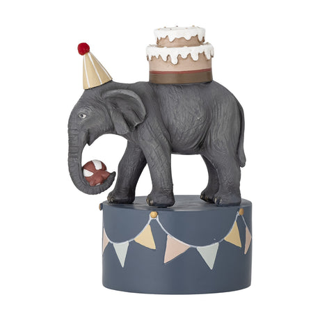 Flor Resin Candle Holder 18cm in multicoloured resin, shaped as an elephant in a party hat balancing a two-tier cake and ball, on a bunting-decorated round base, plain white background.